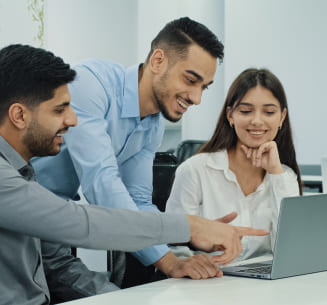 A group of people looking for something in the computer