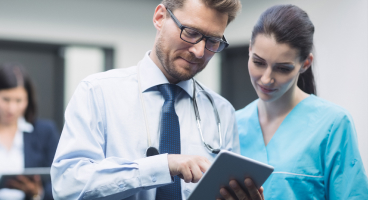 doctor nurse discussing digital tablet